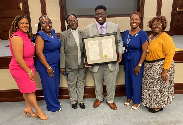 Boys &amp; Girls Club of the Pee Dee Area Traditional Youth of the Year, Justin K. McNair  of Lake City is joined by family as he is presented with a Concurrent Resolution from the South Carolina General Assembly.