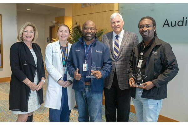 Values in Action Respect awardees Keith Smalls, center, and Donnie Singleton, far right, celebrate with first lady Kathy Cole, from left, nominator Dr. Ashley Hink and MUSC President David Cole. Photos by Sarah Pack