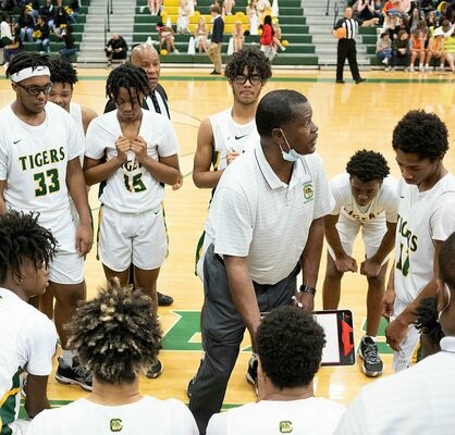 Coach Michael Hopkins gathers with the Tigers in the game with River Bluff