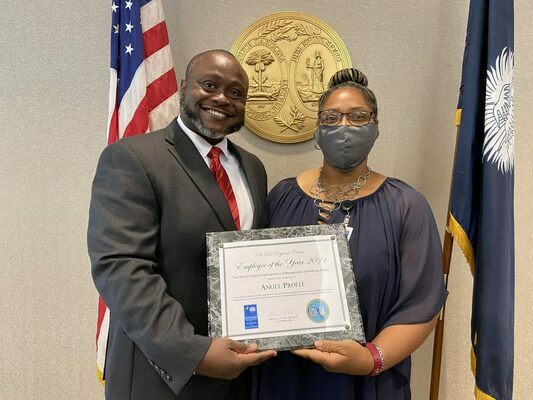 DDSN Facility Administrator Franco Vaval (L) and Pee Dee Regional Center Employee of the Year Angel Profit (R)
